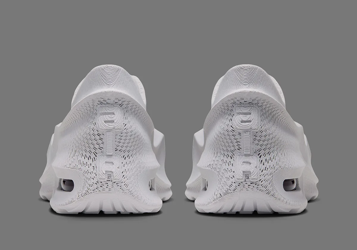 heel view of a pair, ribbed white texture with embossed AIR lettering above visible air units, Air Max 1000.3