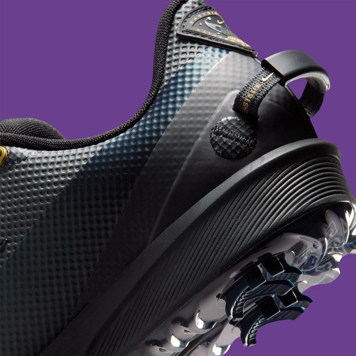 close-up detail of heel pull tab and ridged midsole with gold Eastside Golf text, x Eastside Golf