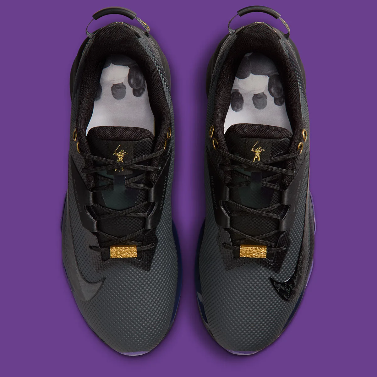 top-down pair view revealing black and white illustrated golfer insoles, x Eastside Golf