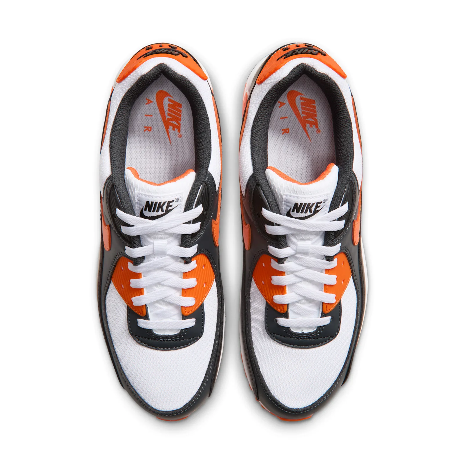 top-down pair view, white laces and orange Nike Air text on insoles, Air Max 90