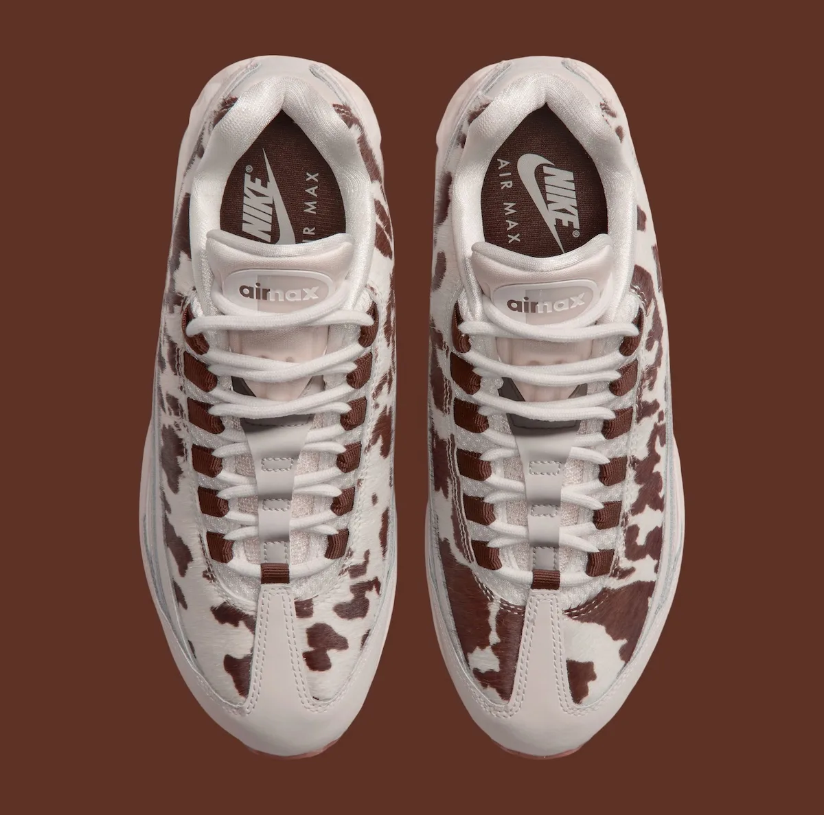 top-down view of pair, cow-print vamps with brown Air Max branded tongues, Cow Print