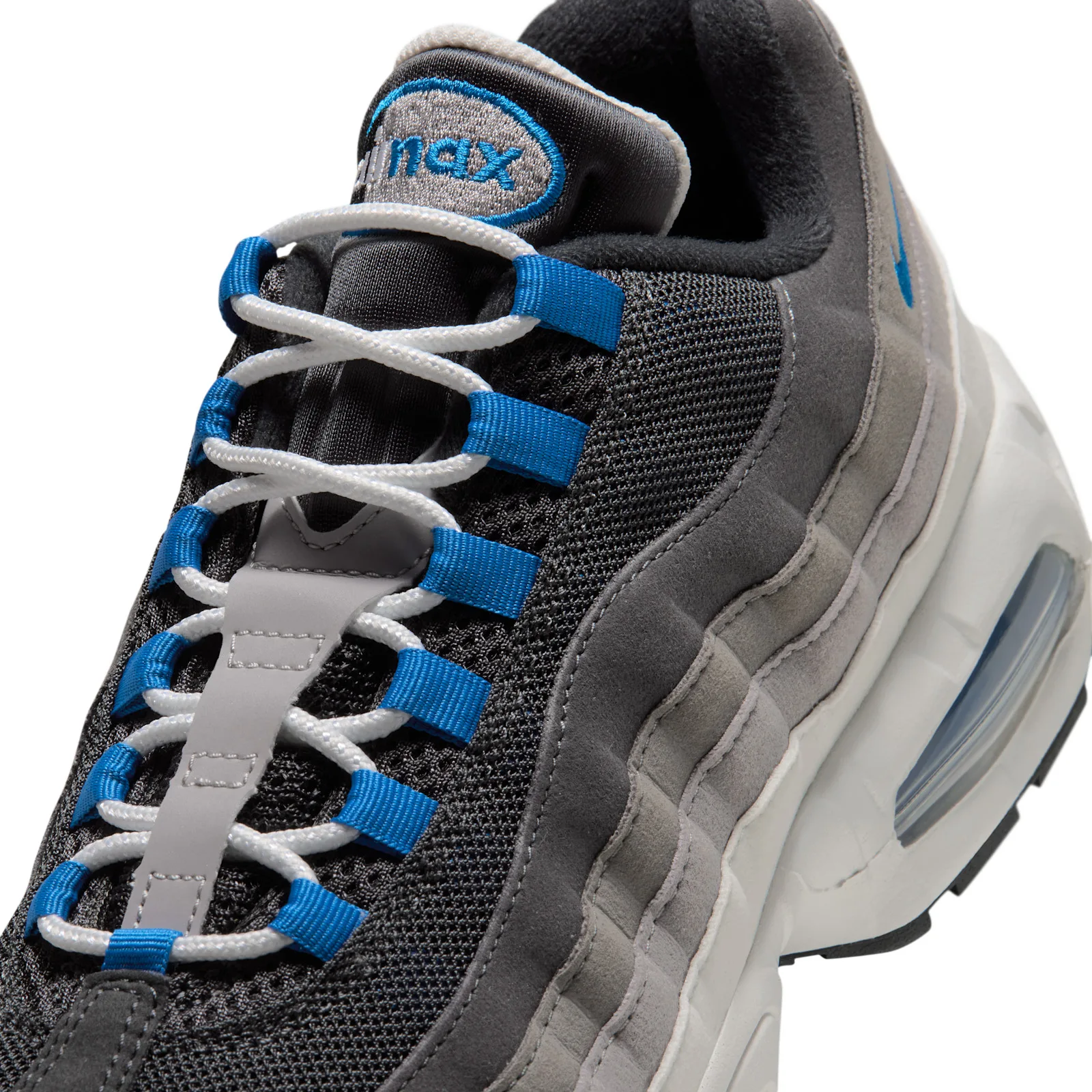 Close-up tongue detail showing blue lace loops, air max tag and grey layered panels, Reverse Blue Spark