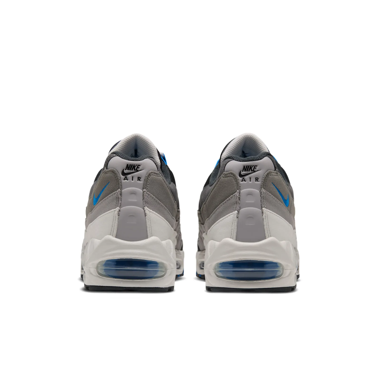 Heel view of pair showing black Nike Air text tabs and blue-tinted Air units, Reverse Blue Spark