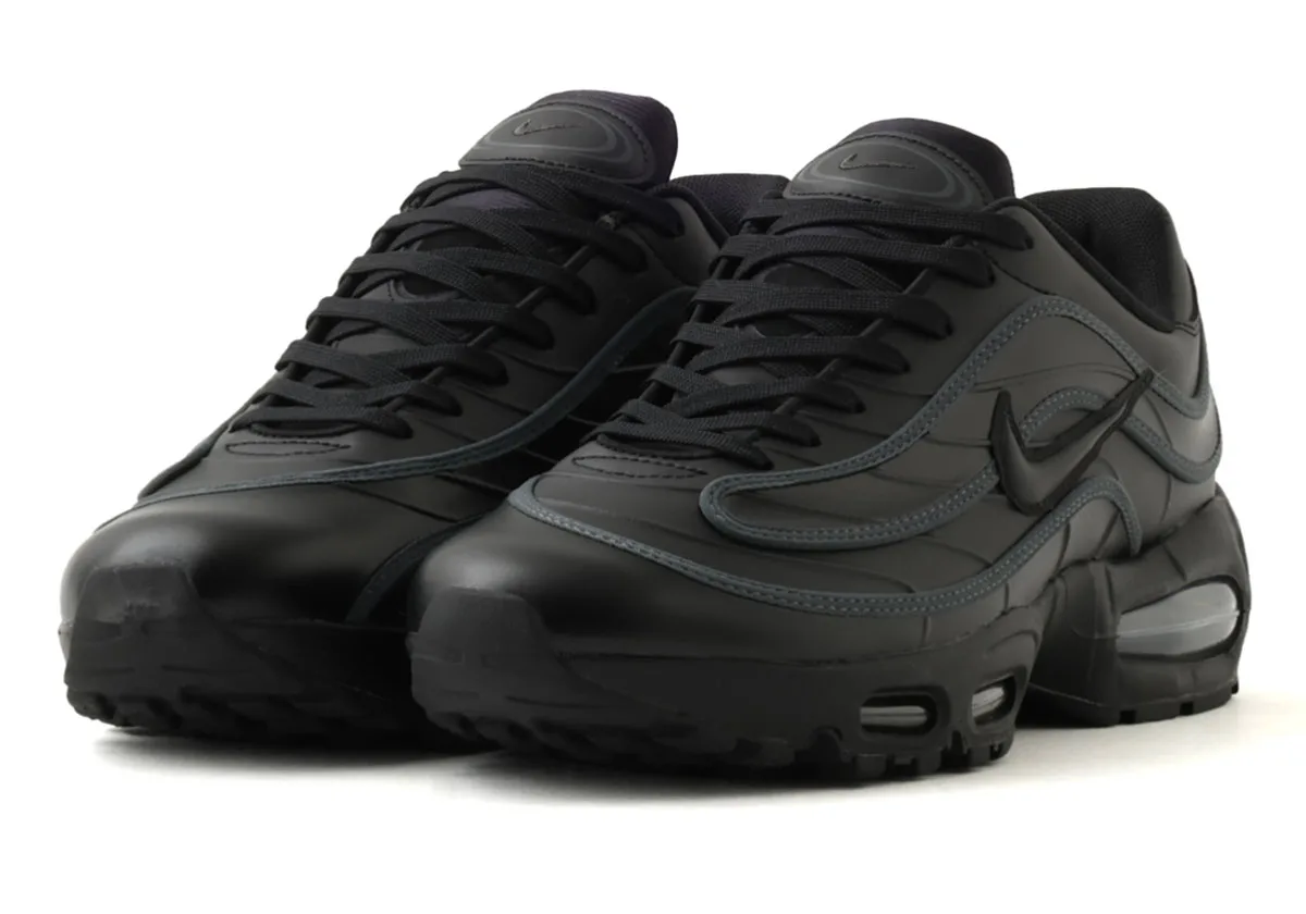 toe/front angled pair view, black leather uppers with grey trim and visible air unit, Max Joga Bonito