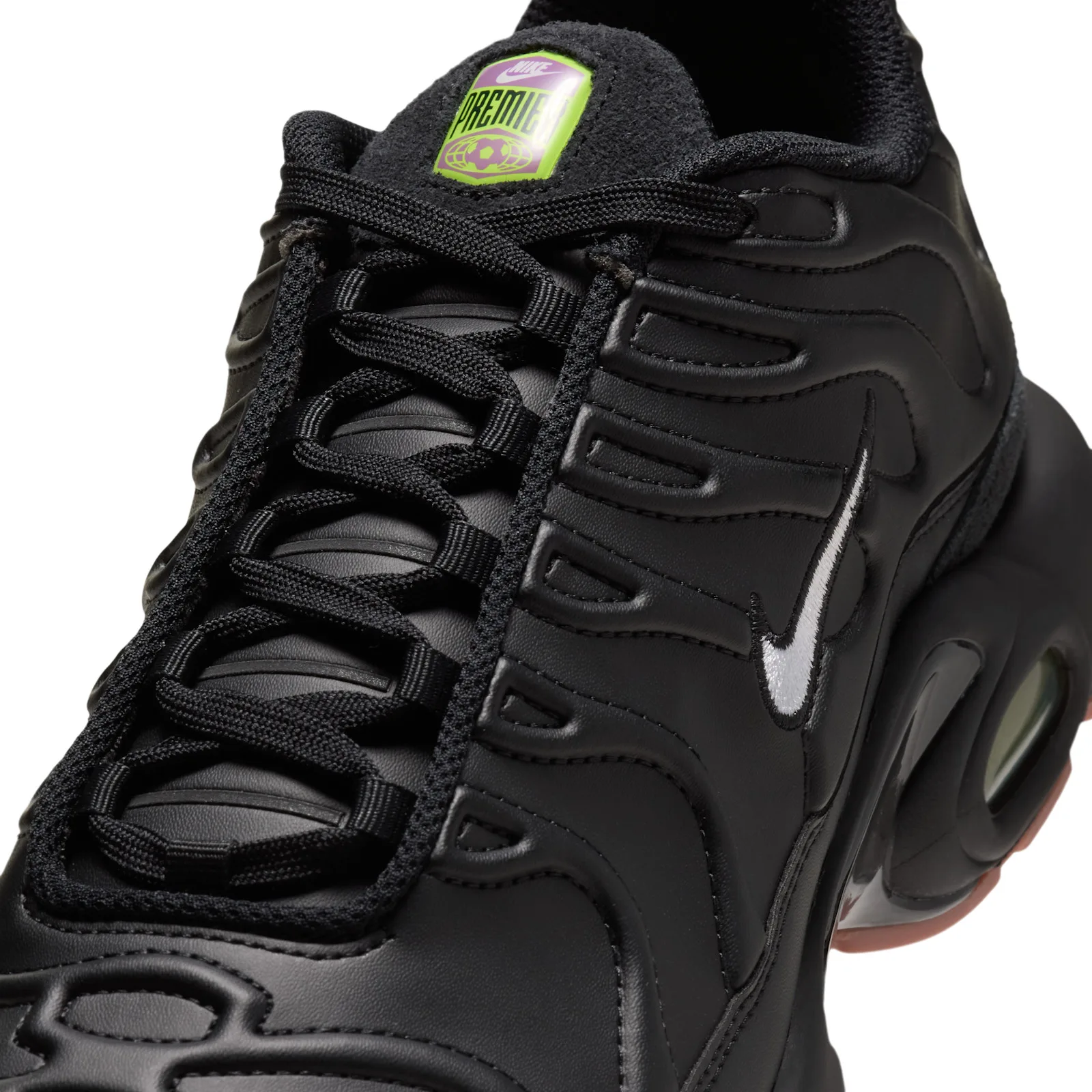 close-up of tongue and toe, purple-green 'PREMIER' tab, white swoosh, black leather panels, Premier