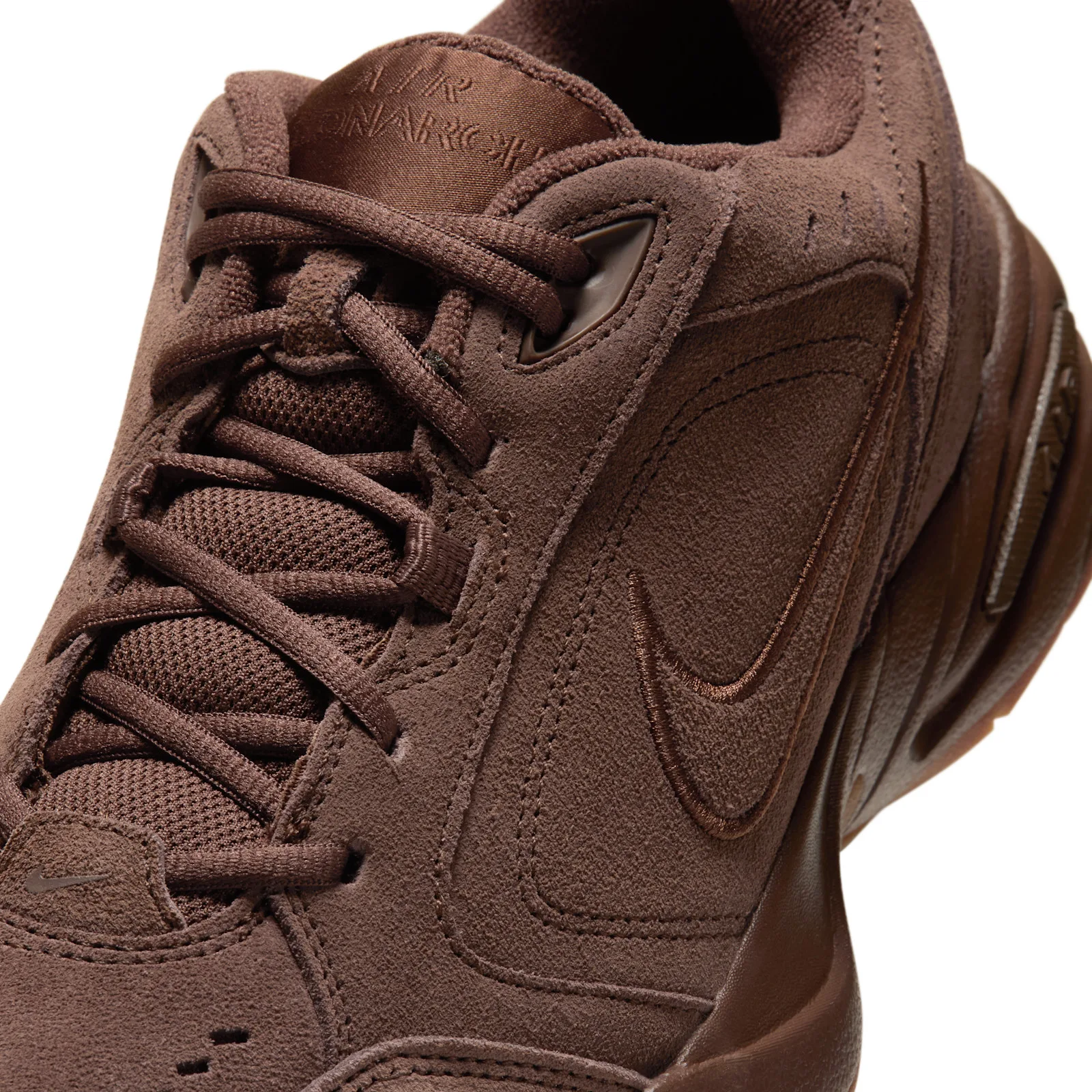 close-up medial detail, tonal stitched swoosh and mesh tongue with AIR MONARCH text, Suede