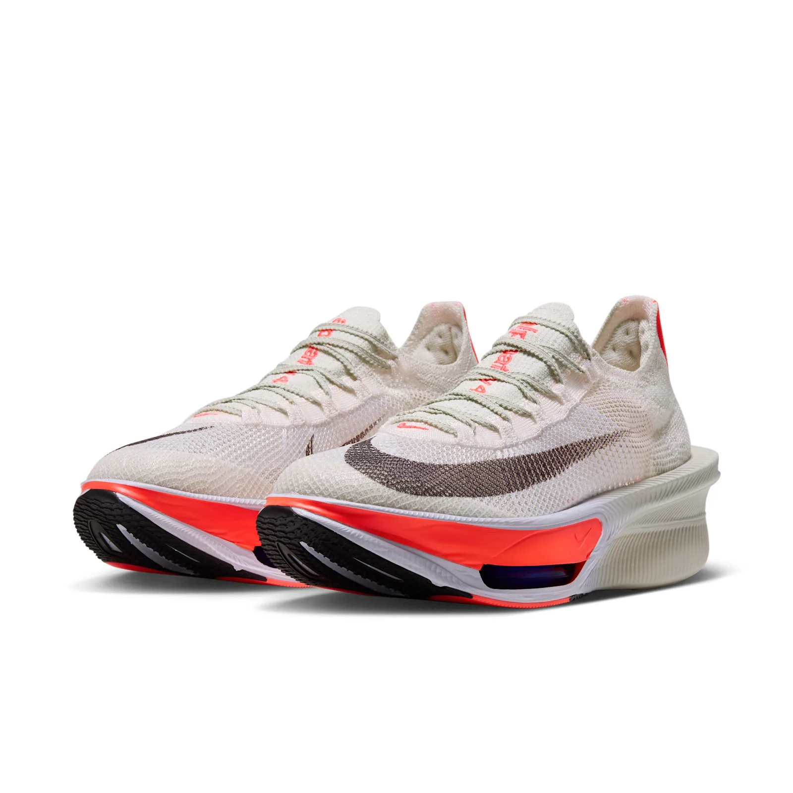 pair, front three-quarter view, white knit uppers, crimson midsole accents, black Swoosh, Nike AlphaFly 4