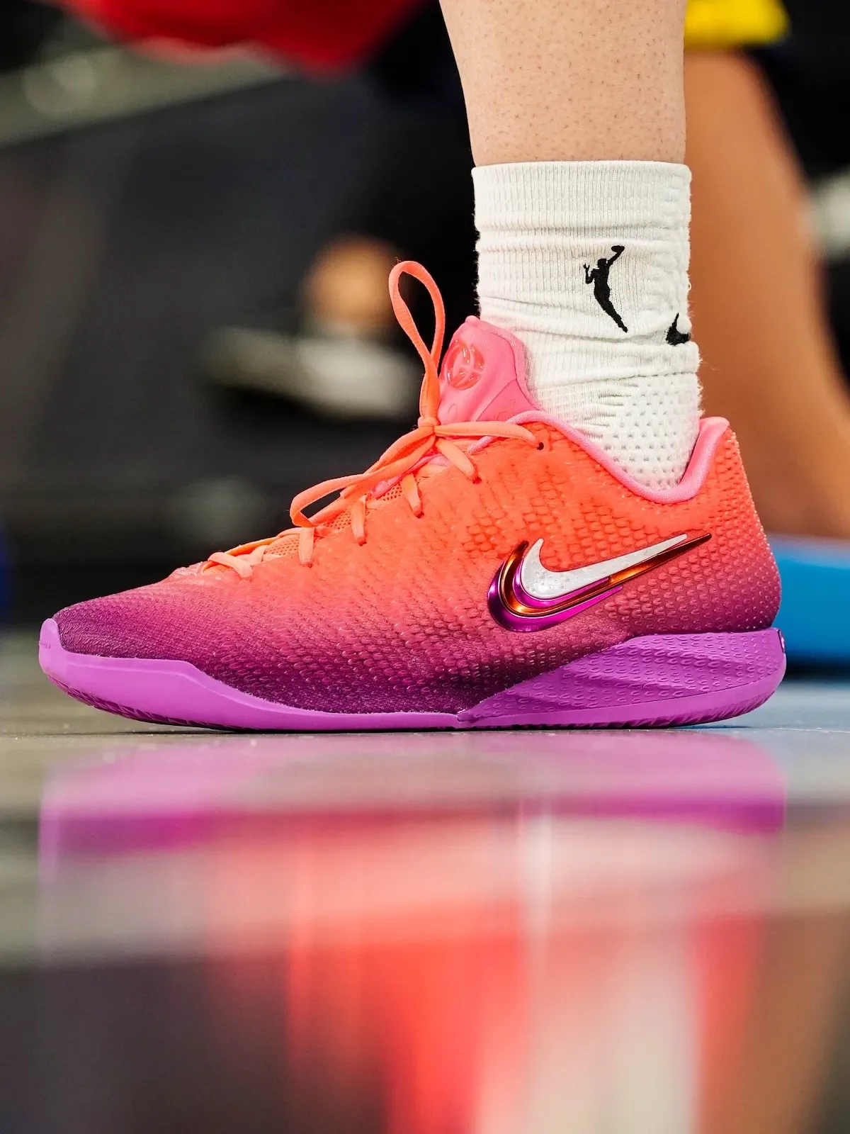 On-foot lateral close-up, orange upper into purple sole, pink heel counter, Berry Fade