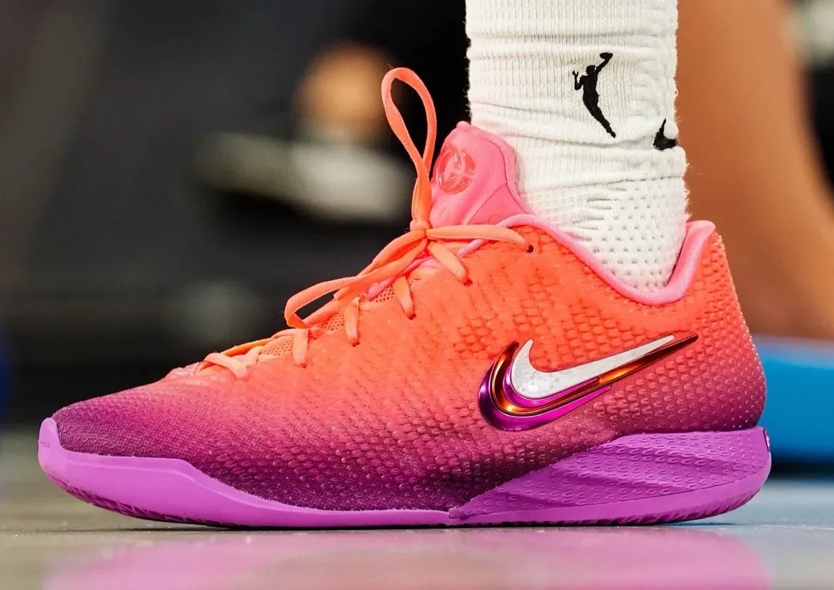 On-foot lateral close-up, orange upper fading to purple sole, pink heel patch, Berry Fade