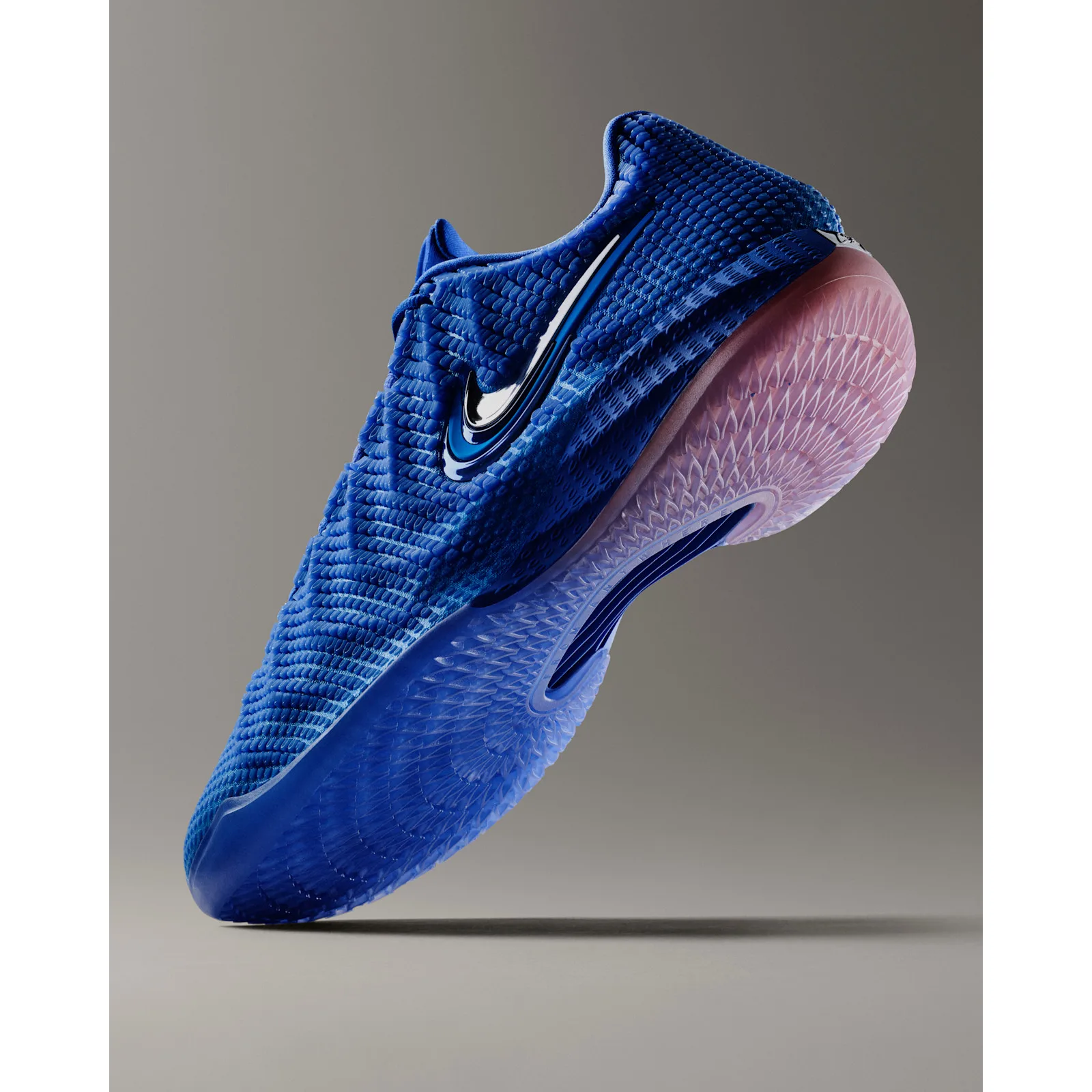 angled toe-to-heel shot on grey backdrop, blue upper with pink outsole, Racer Blue/Pink