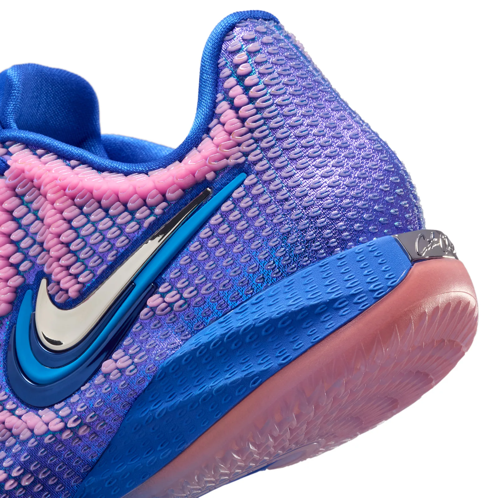 close-up of heel and swoosh, pink-to-purple knit with chrome accent, Racer Blue/Pink