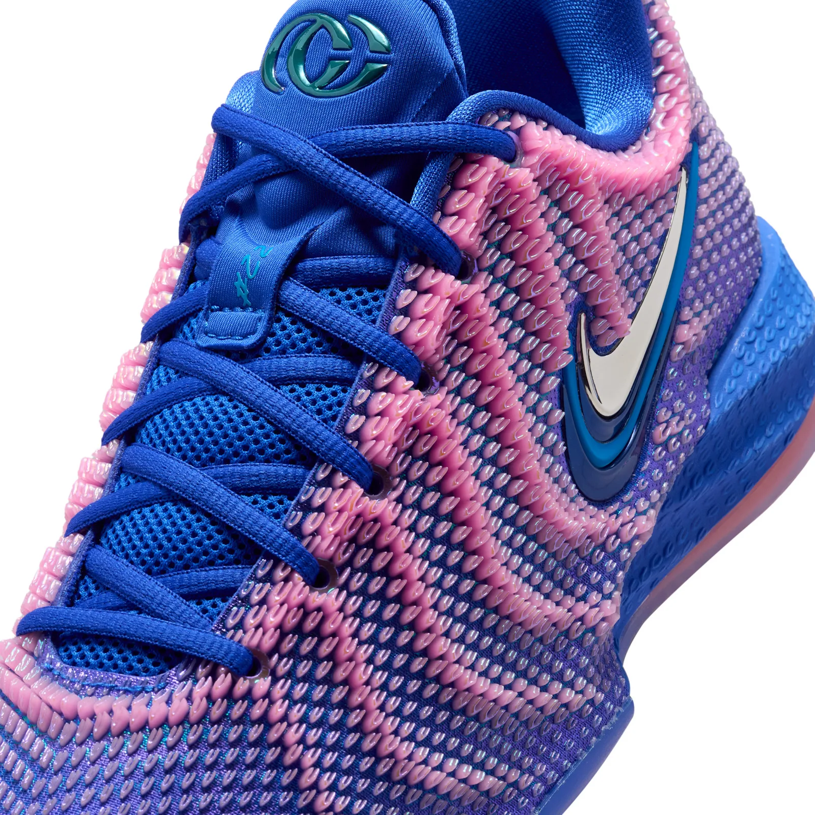 close-up of toe area, pink knit weave with chrome swoosh, Racer Blue/Pink