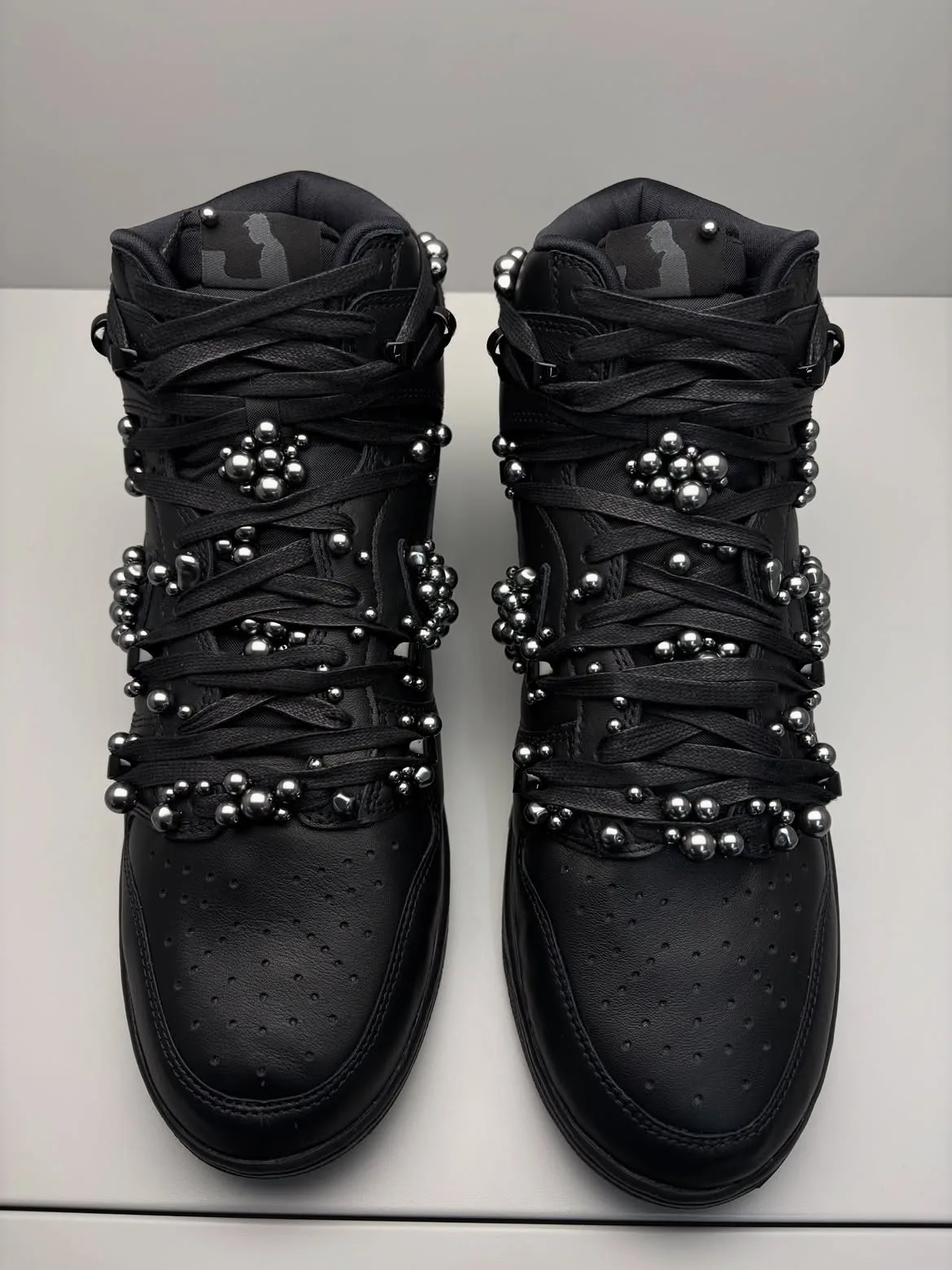 toe-down pair, matte black leather with clustered silver bead embellishments, Maestro 1