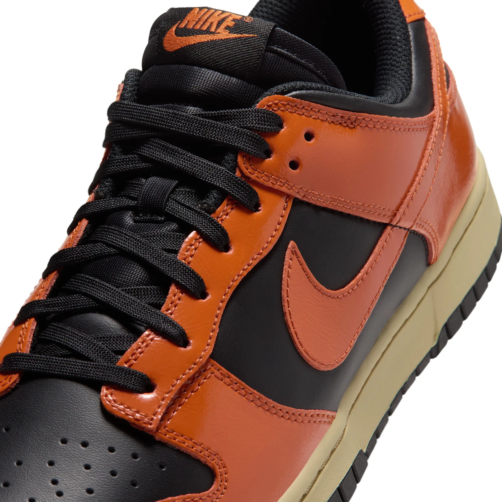 Toe and swoosh close-up, black leather with orange overlay and eyelets, Campfire Orange