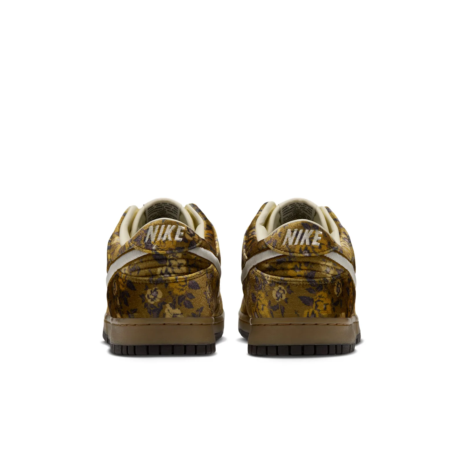 heel view of pair, cream NIKE text on heel tabs, floral velvet, Golden Hops/Velvet Brown