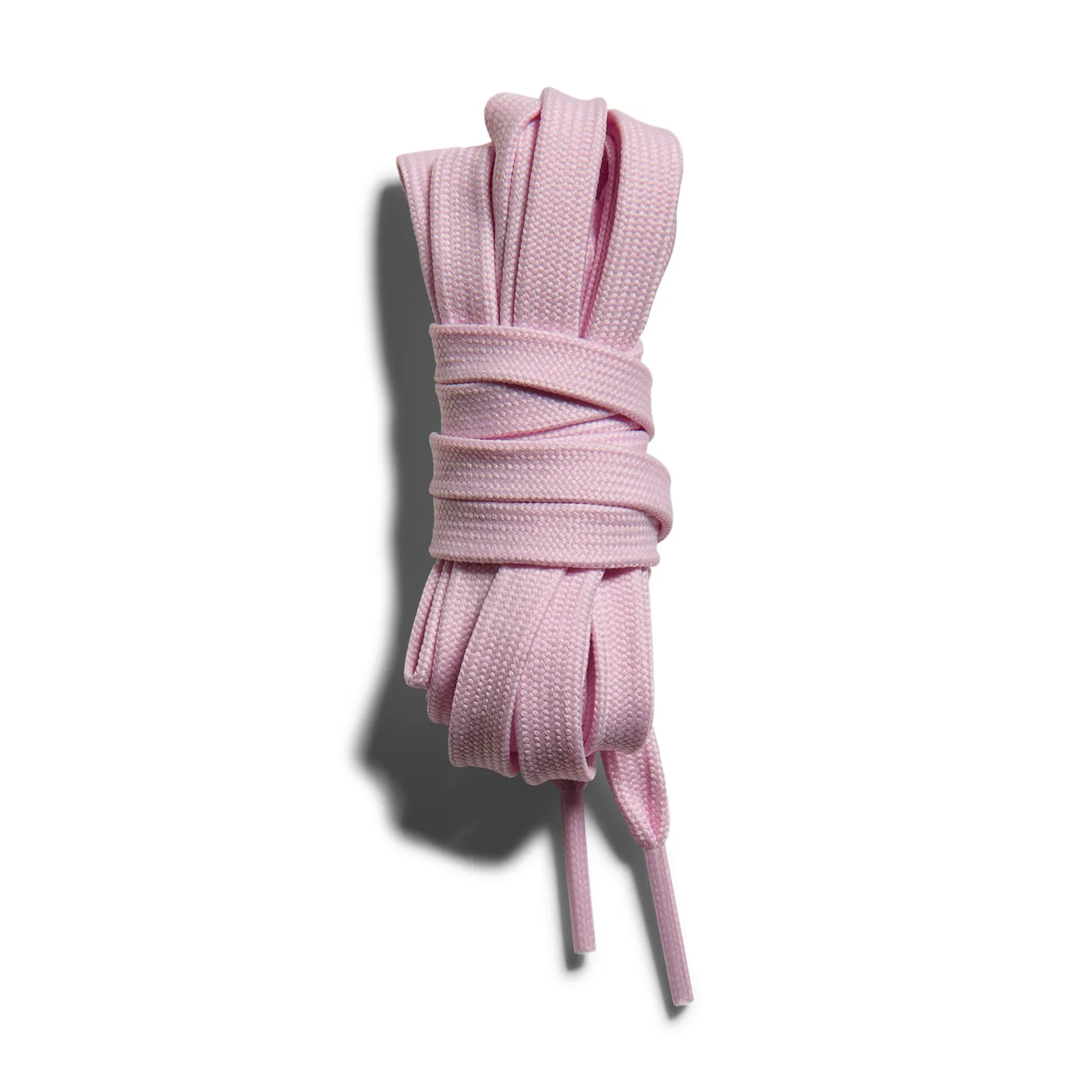 detail shot of coiled pink woven laces on white background, Pink Foam