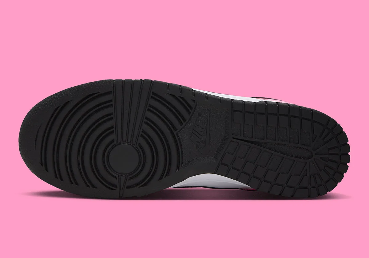 outsole view, black tread pattern with NIKE logo at arch, Pink Spell