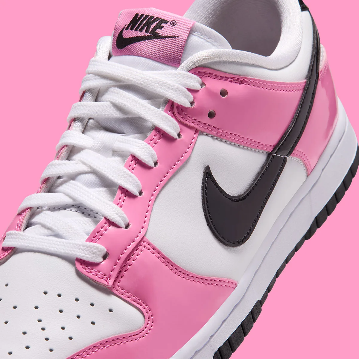 close-up of toe and swoosh, pink patent overlays and black patent detailing, Pink Spell