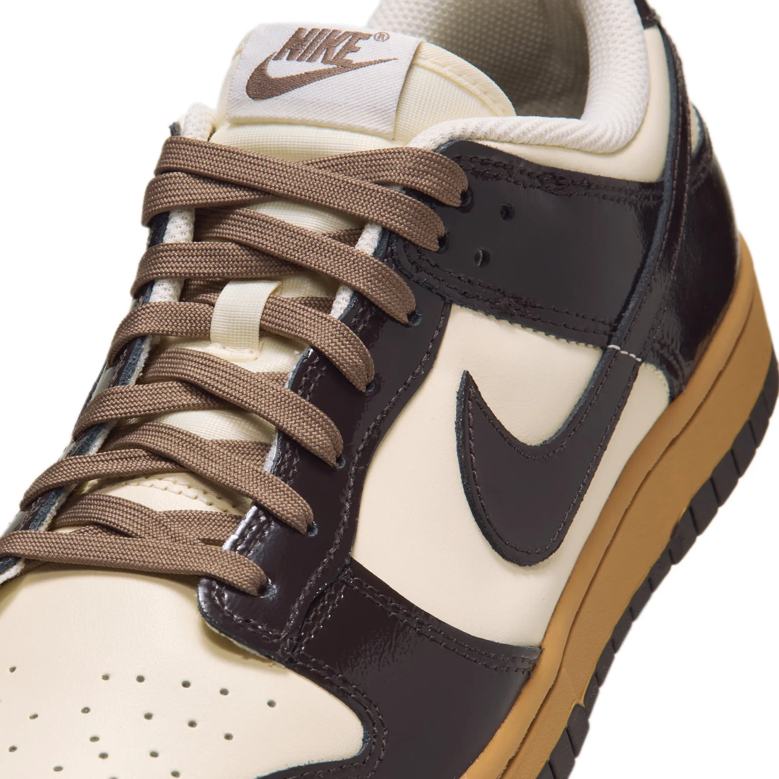 close-up lateral toe detail, dark brown swoosh, cream Nike tongue tag, Shadow Brown
