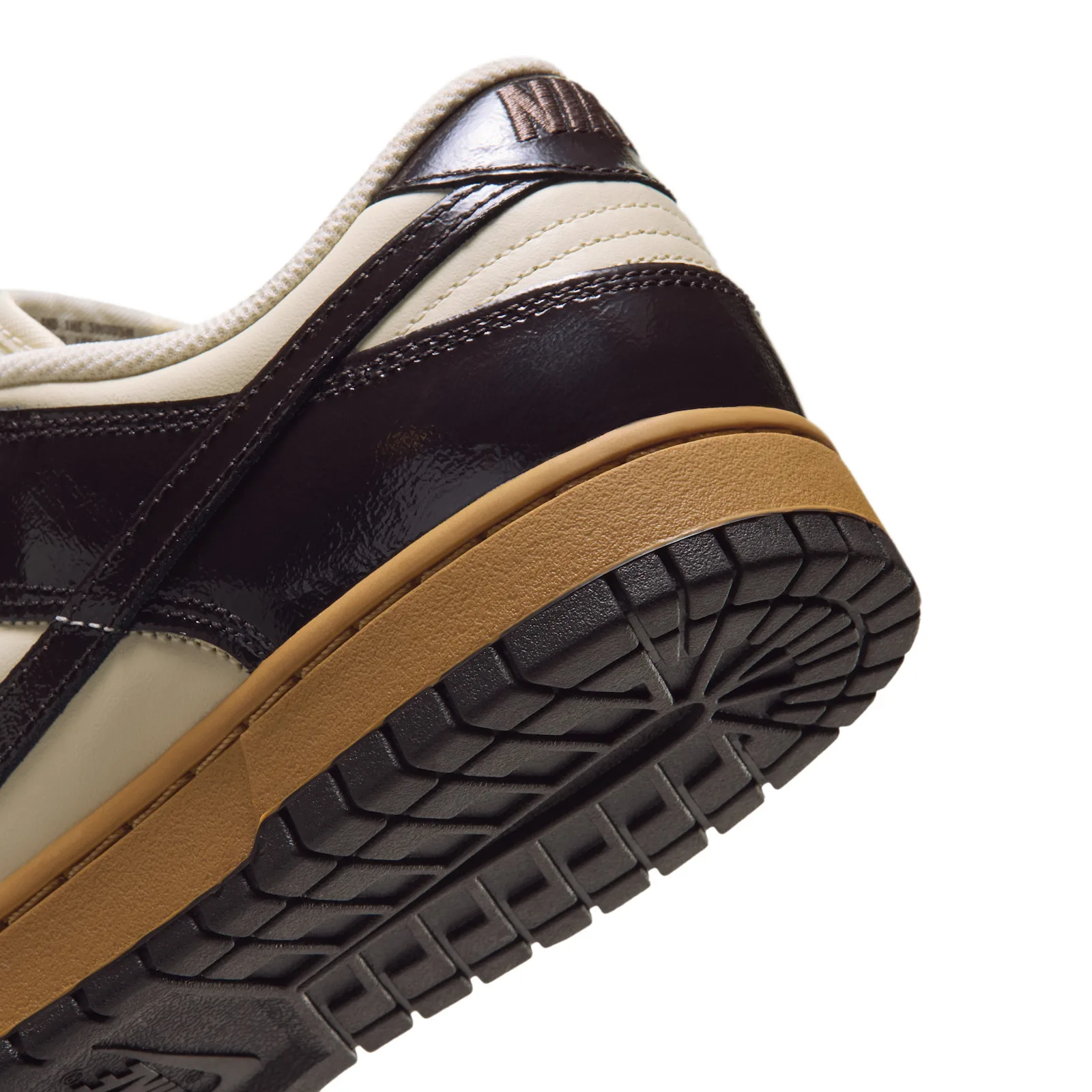 close-up lateral toe detail, dark brown swoosh on cream, tan laces, Shadow Brown