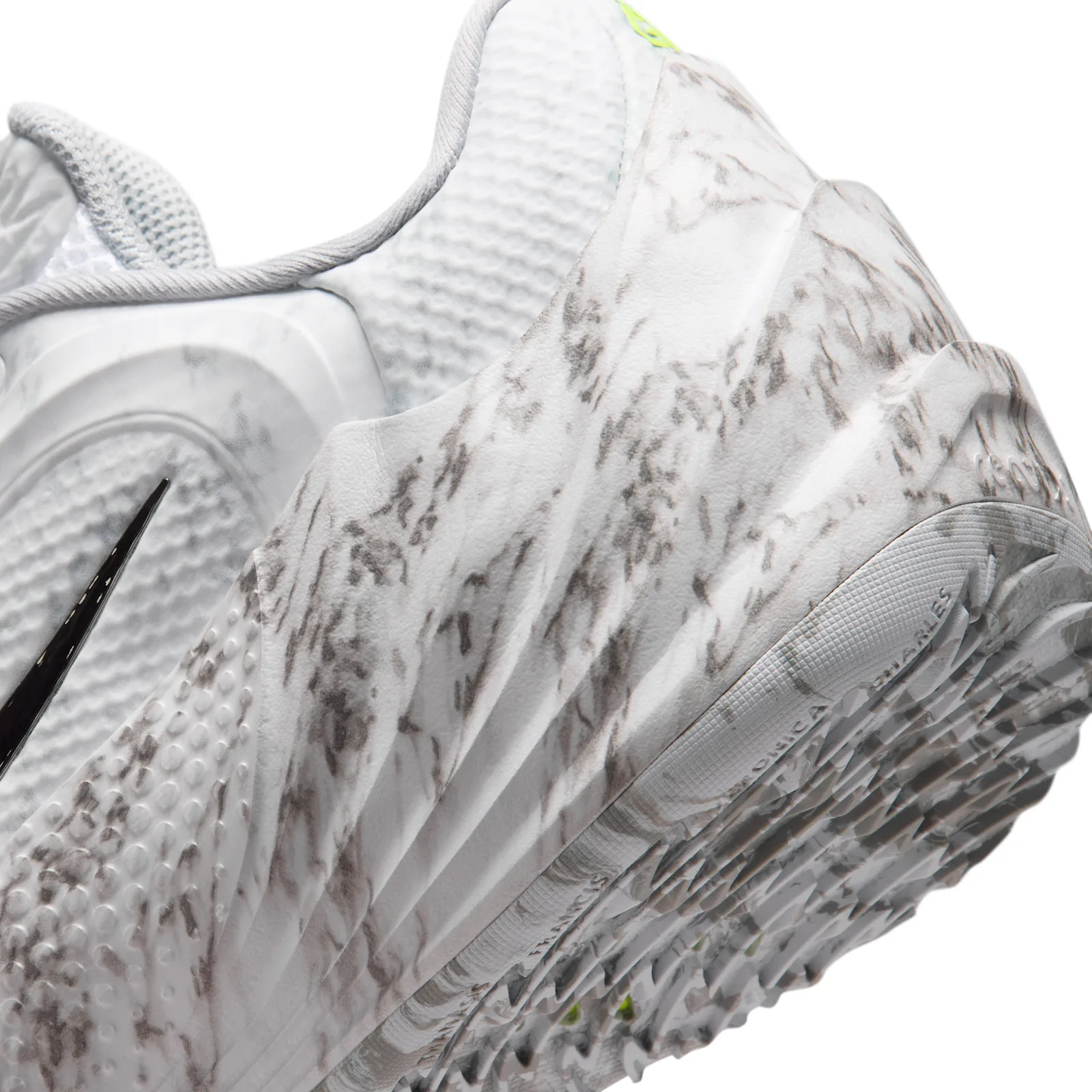 Macro detail, marbled outsole tread with faint lettering near heel, Etched in Stone
