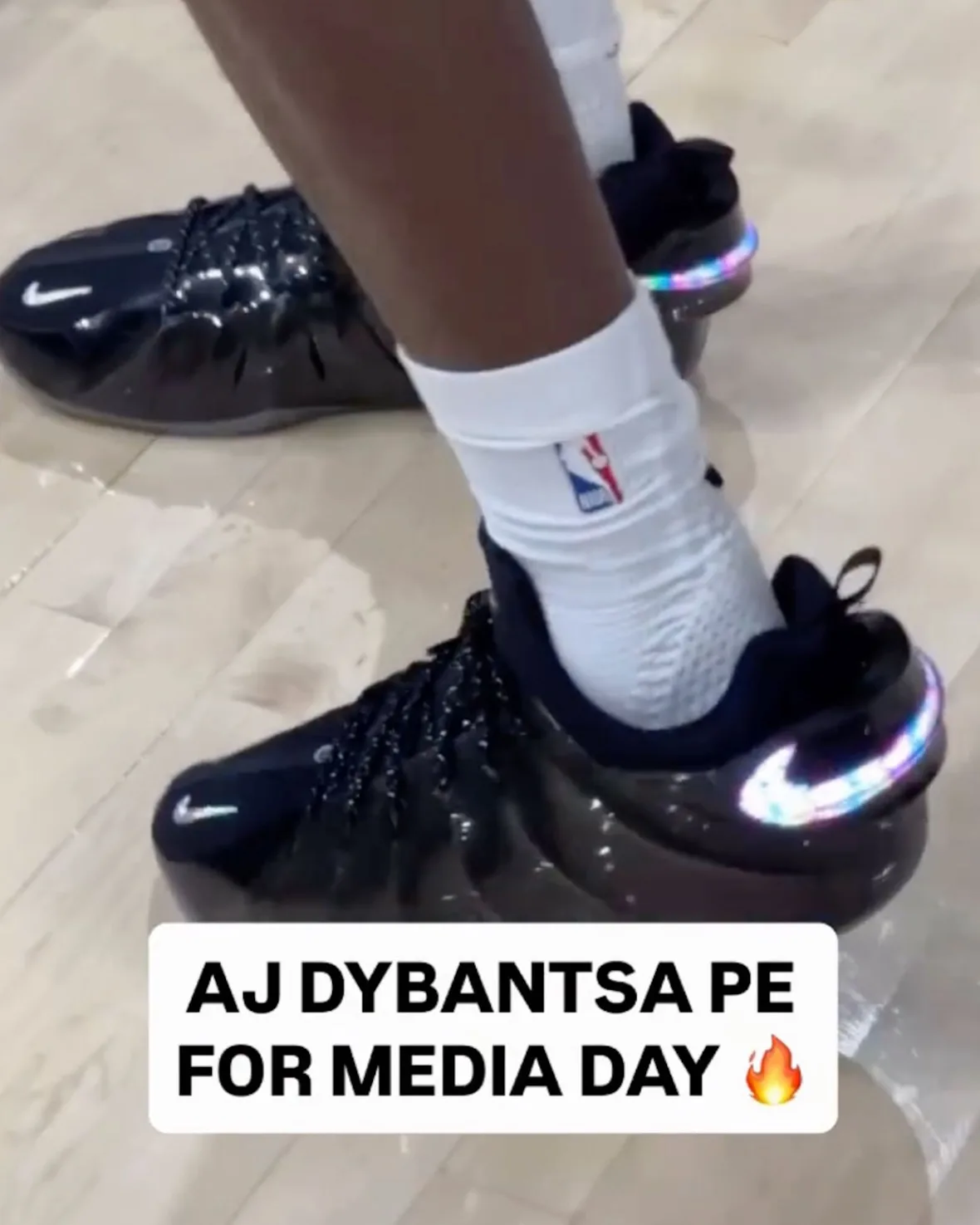 on-foot pair, black with NBA sock and rainbow iridescent heel swoosh, Nike GT Flight