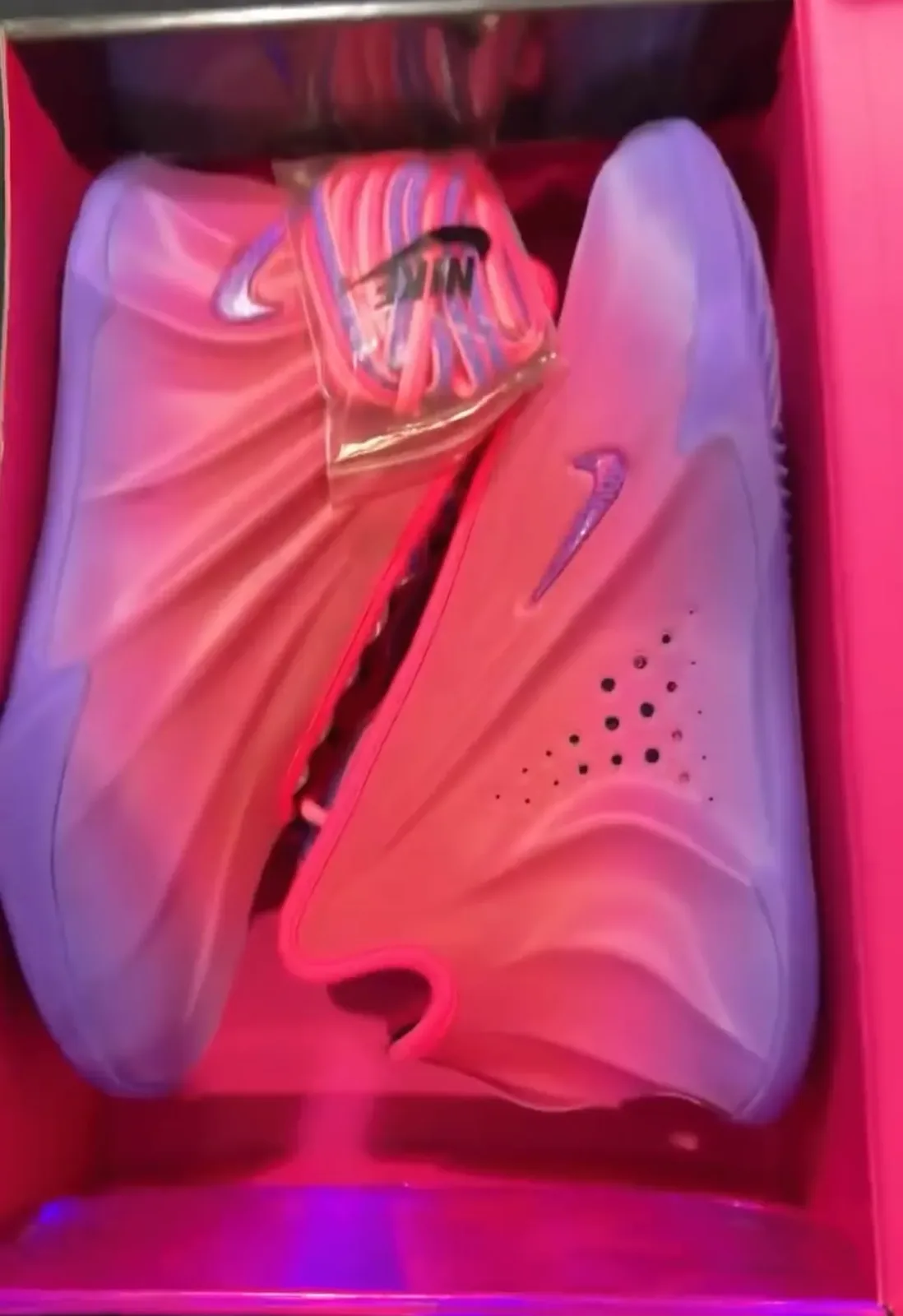 top-down view in pink box, pink-to-purple gradient pair with purple 'nike' text on sole, The Better Generation