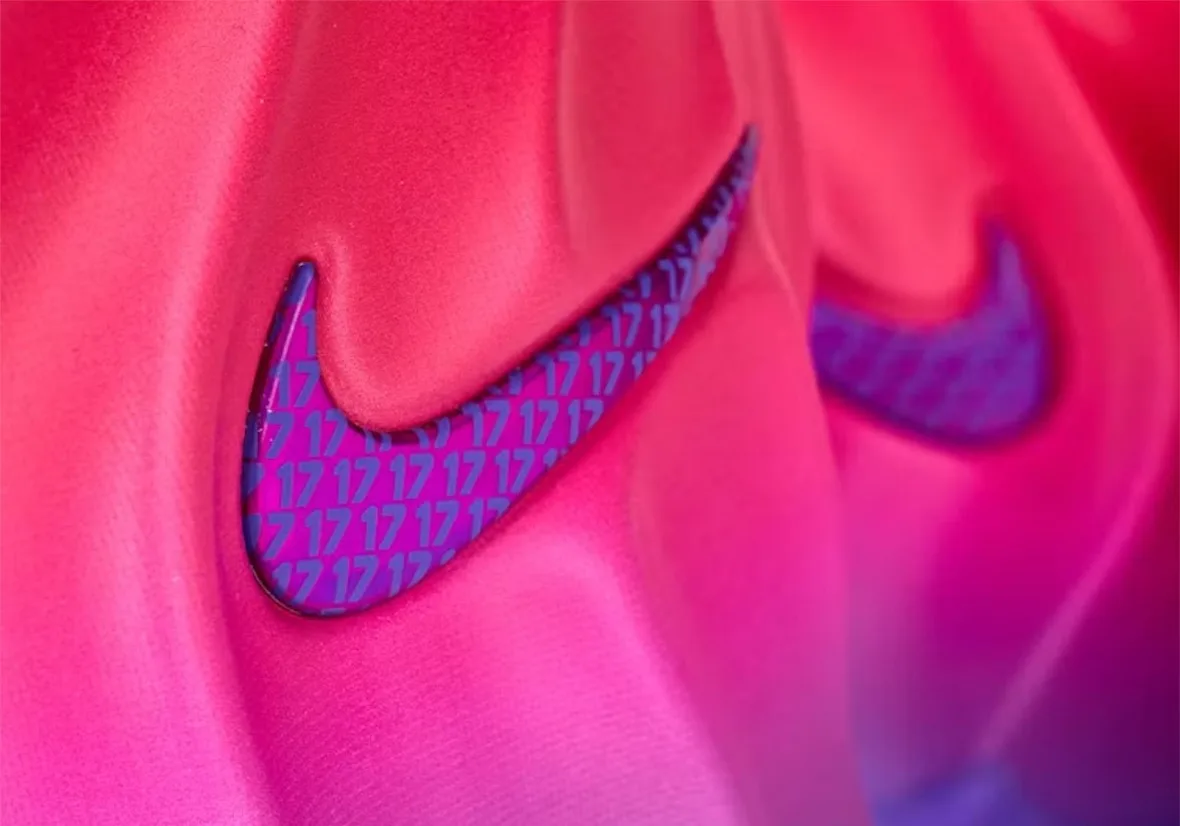 macro detail of two iridescent swooshes with repeating '17' pattern on pink upper, The Better Generation
