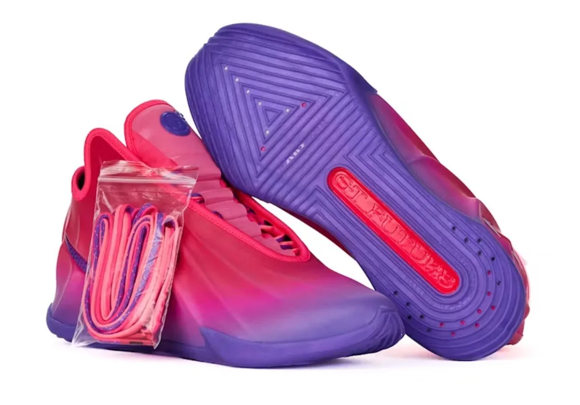 pair with one shoe inverted showing purple outsole and red text, spare laces in a bag, The Better Generation