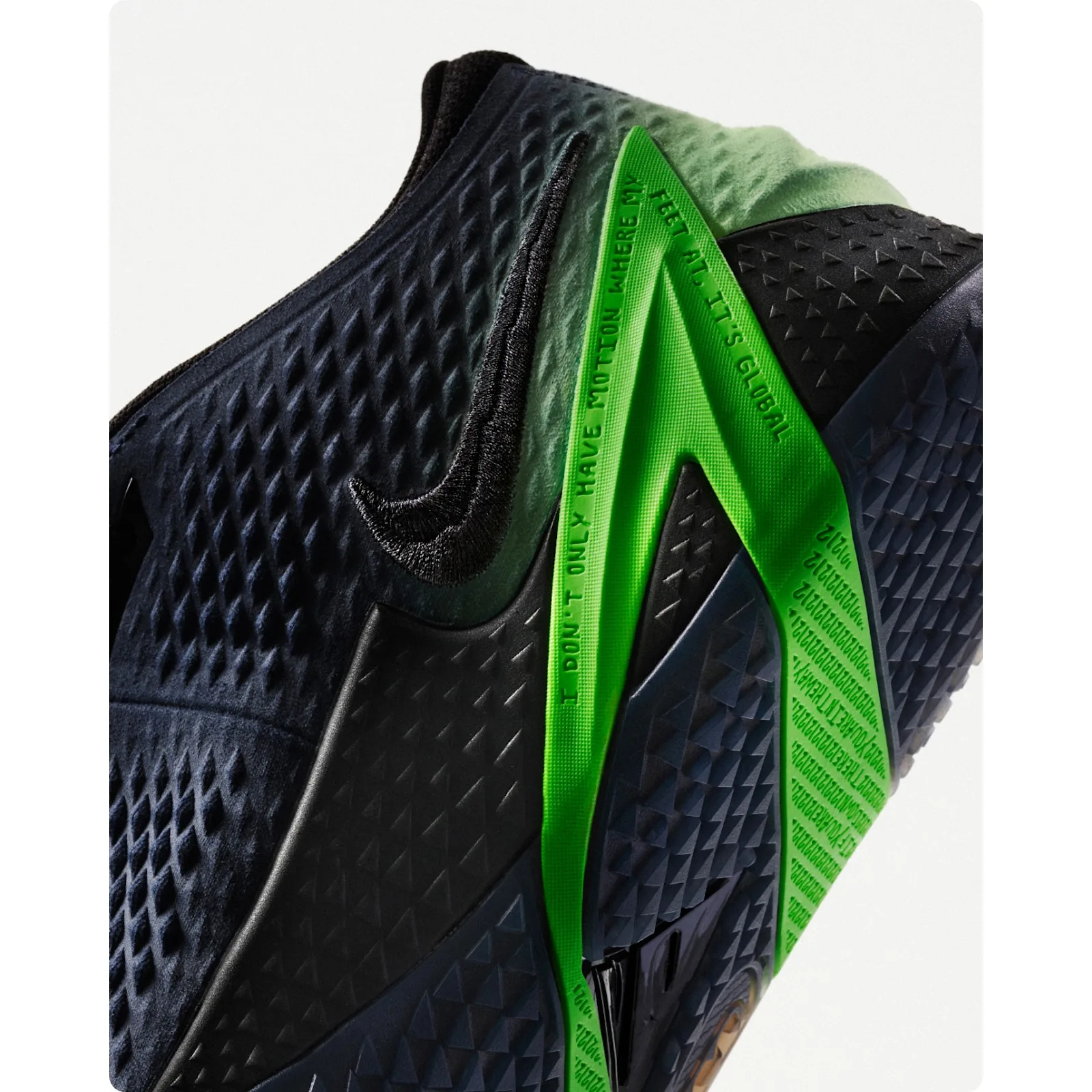 detail of green pull tab with embossed text, black textured heel and swoosh, Dark Mode