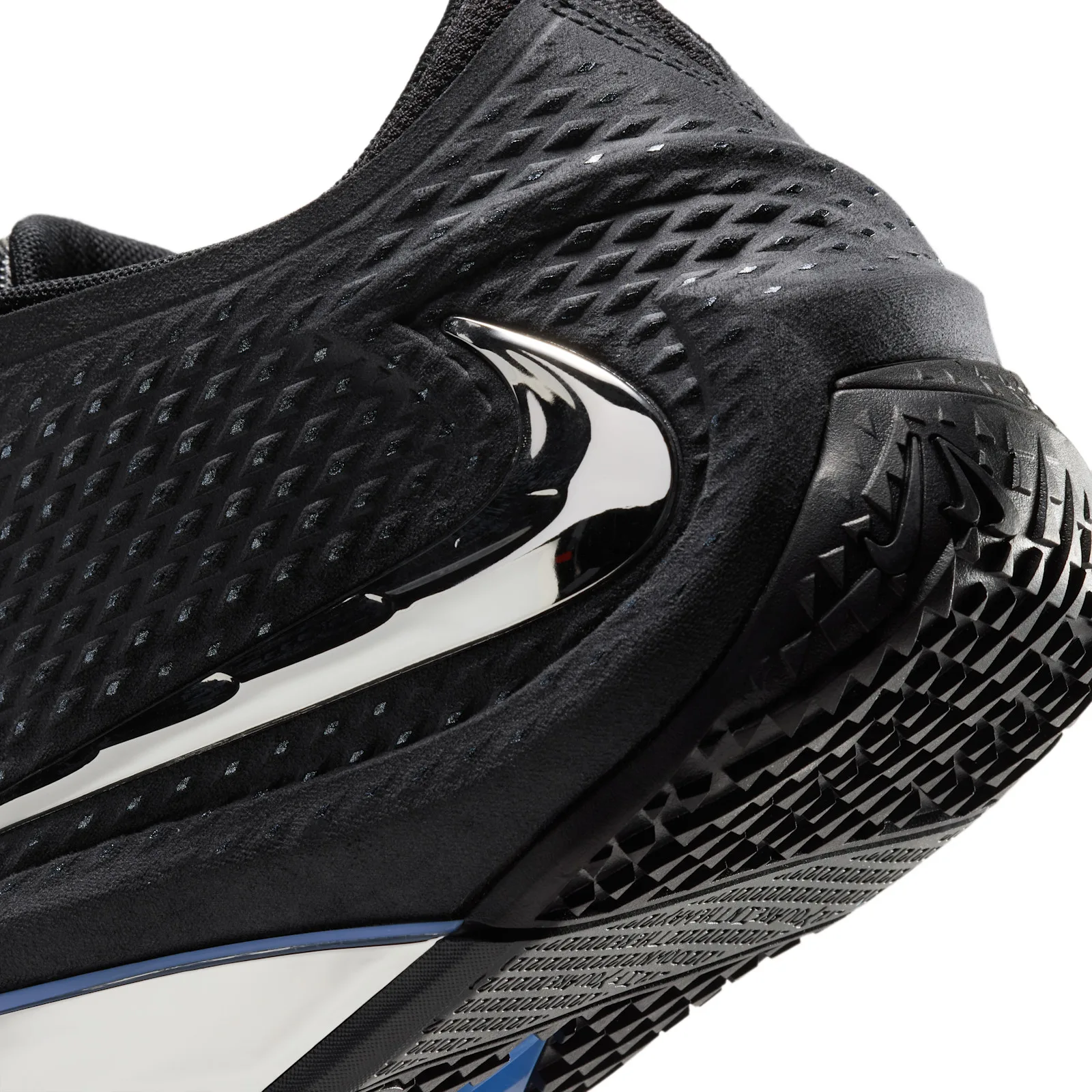 close-up of heel cup, chrome swoosh, black tread with embossed text, Dark Mode