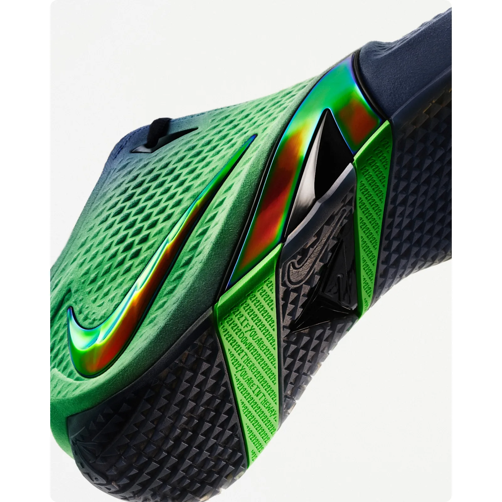 detail of green toe and midsole, iridescent swoosh, green pull tab with text, Dark Mode