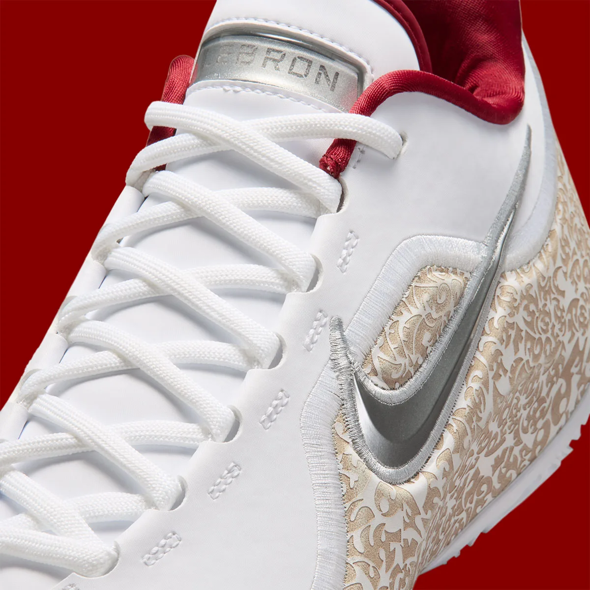 close-up of toe box with silver swoosh and embossed LEBRON tongue tag, Laser