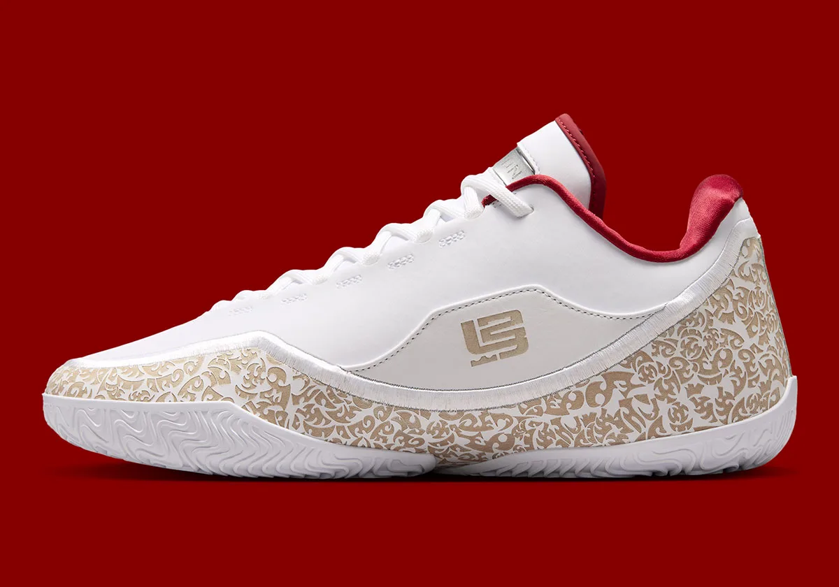 lateral view, white upper with gold paisley print and dark red heel lining, Nike LeBron 23 "Laser"