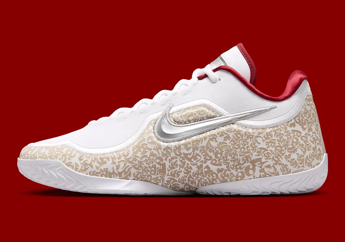 lateral close-up showing silver swoosh over gold paisley print on white leather, Laser