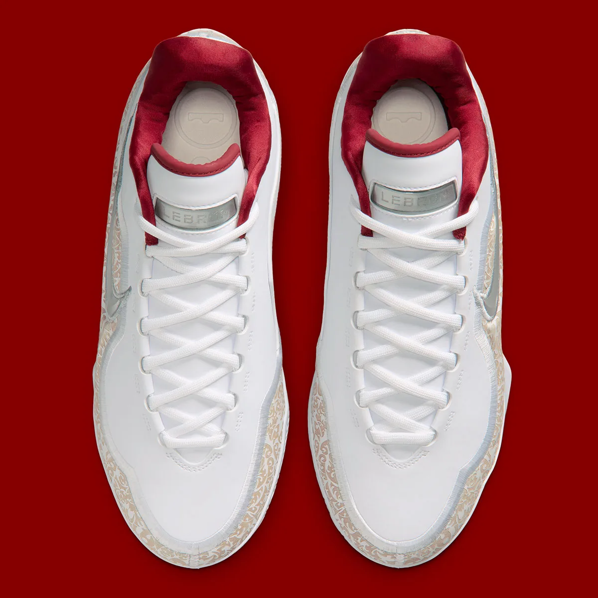 top-down view of laced pair with red tongues and gold-trimmed panels, Laser