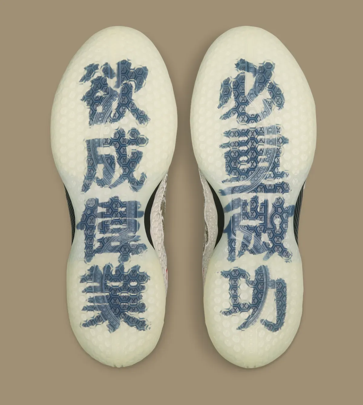 outsole view of the pair, blue Chinese characters printed on a glow-tinted sole, Lunar New Year