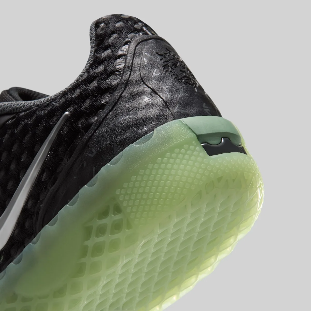 lateral view, black mesh upper with silver swoosh on bright green sole, LeBron Witness 10