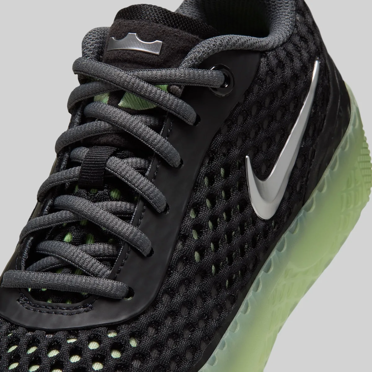 vamp close-up, black mesh with silver swoosh and dark grey laces, LeBron Witness 10