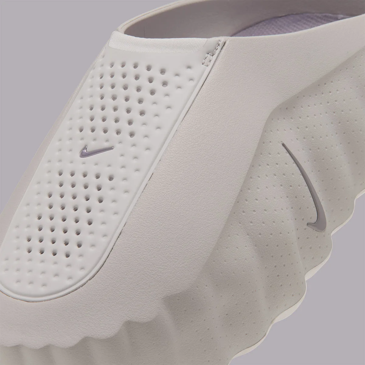close-up heel-to-toe detail of perforated panel, seam stitching and swoosh on ribbed upper, Purple Smoke