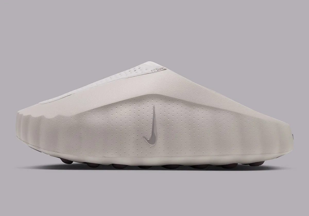 lateral view of off-white slide-style mule with grey swoosh on plain grey background, Purple Smoke