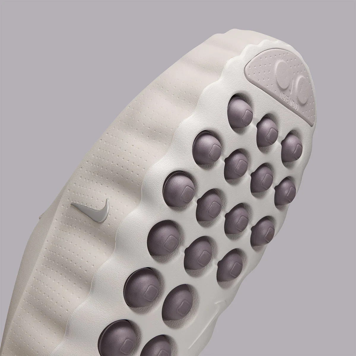close-up angled view of outsole studs with square insets and swoosh on ribbed sidewall, Purple Smoke