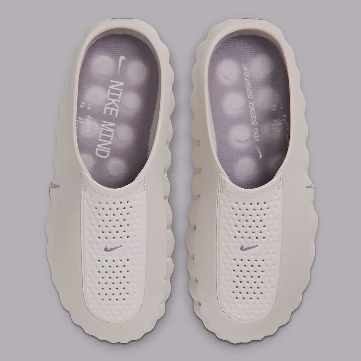 top-down pair view revealing 'NIKE MIND' and 'MIND SCIENCE DEPARTMENT' text on insoles, Purple Smoke
