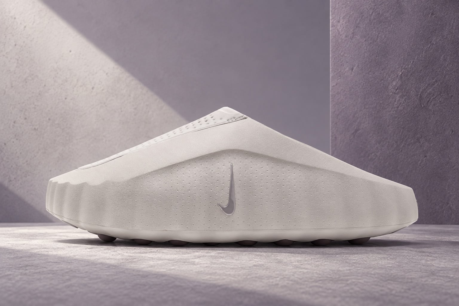 lateral view of off-white slip-on mule with grey swoosh, staged against purple-grey walls, Nike Mind 001 "Purple Smoke"