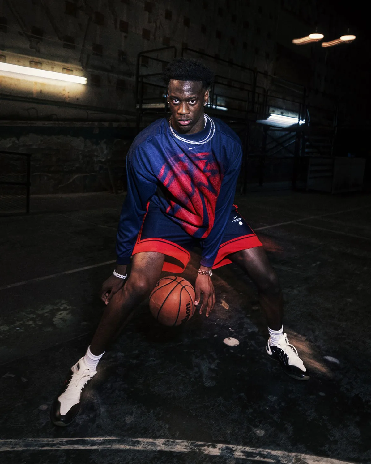on-court, navy long-sleeve with red spray-paint graphic, navy and red shorts, Standard Issue Collection