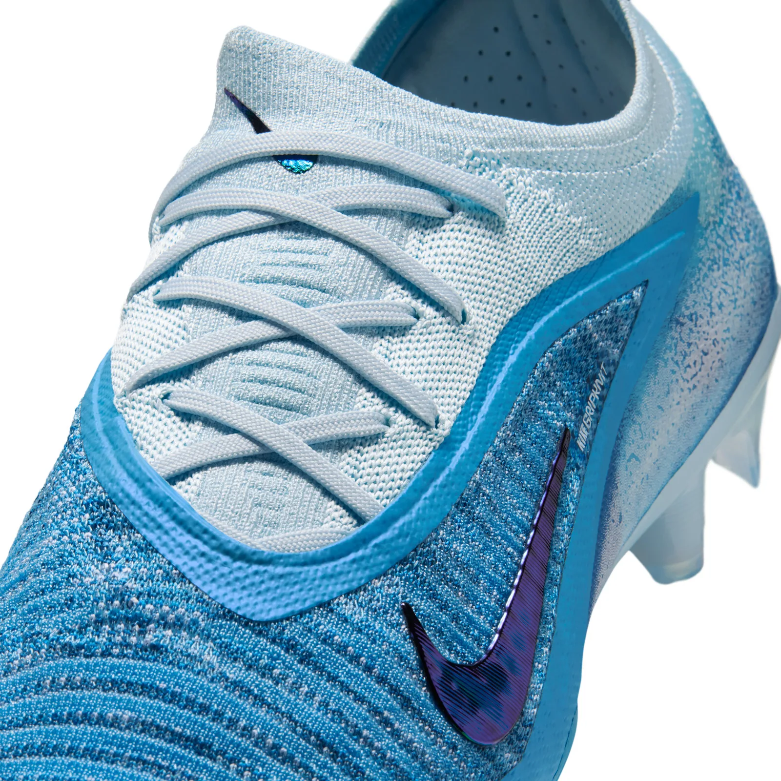 toe and lacing close-up, white knit upper, purple swoosh, gripknit text, Baltic Blue
