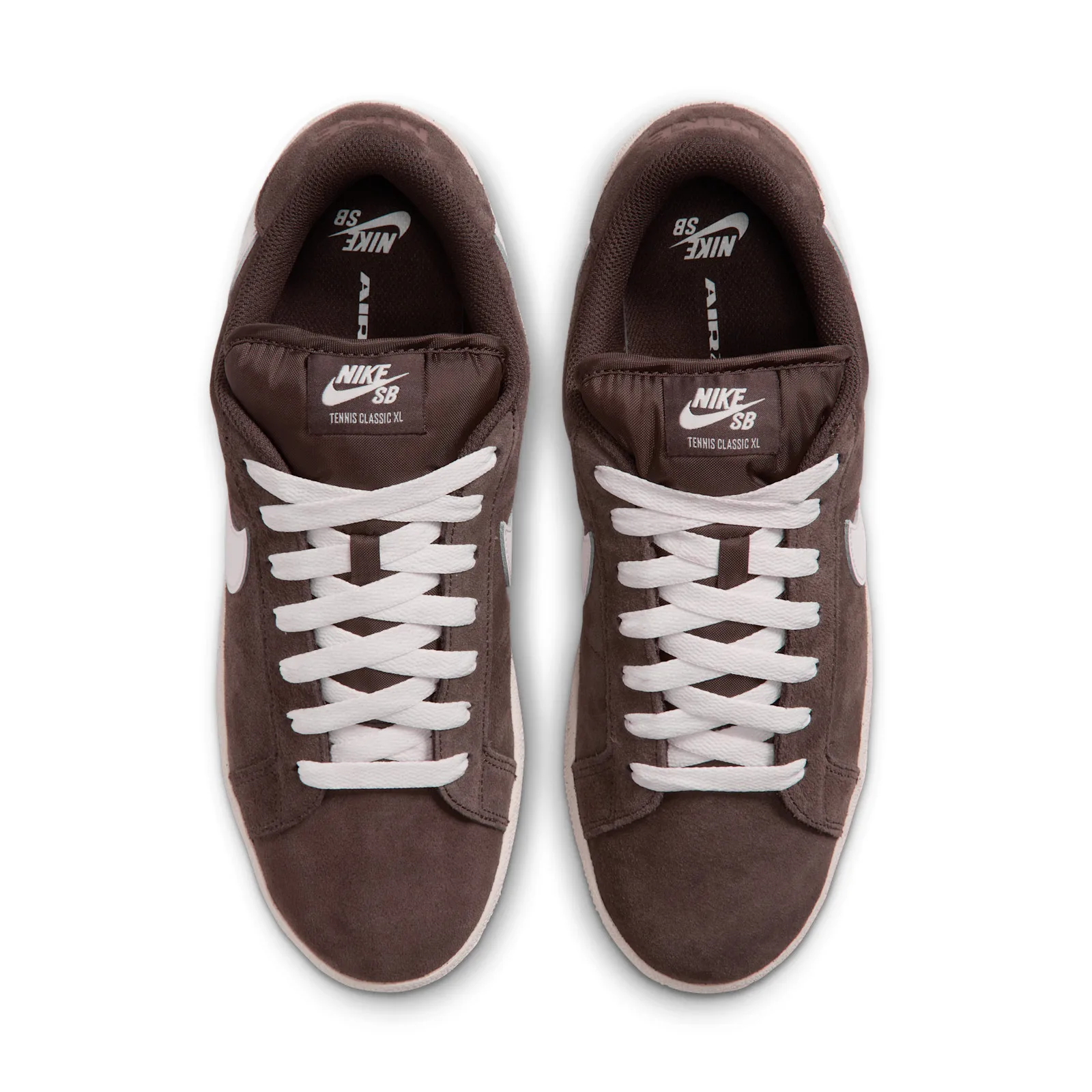 Top-down view of pair, NIKE SB tongue tags read Tennis Classic XL, crossed laces, Baroque Brown
