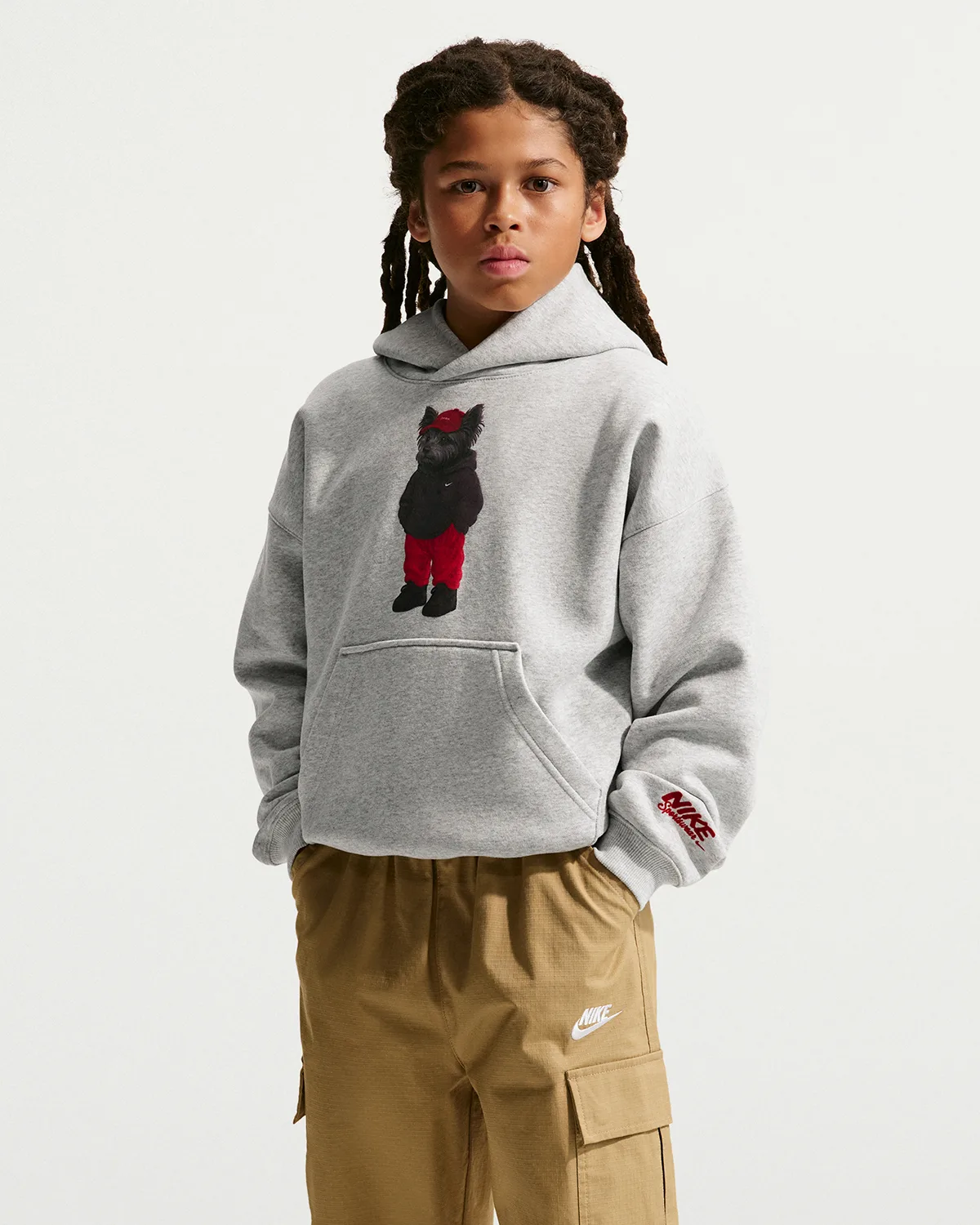 on-foot, boy wears grey hoodie with black dog in red pants chest graphic, Shoe Dog