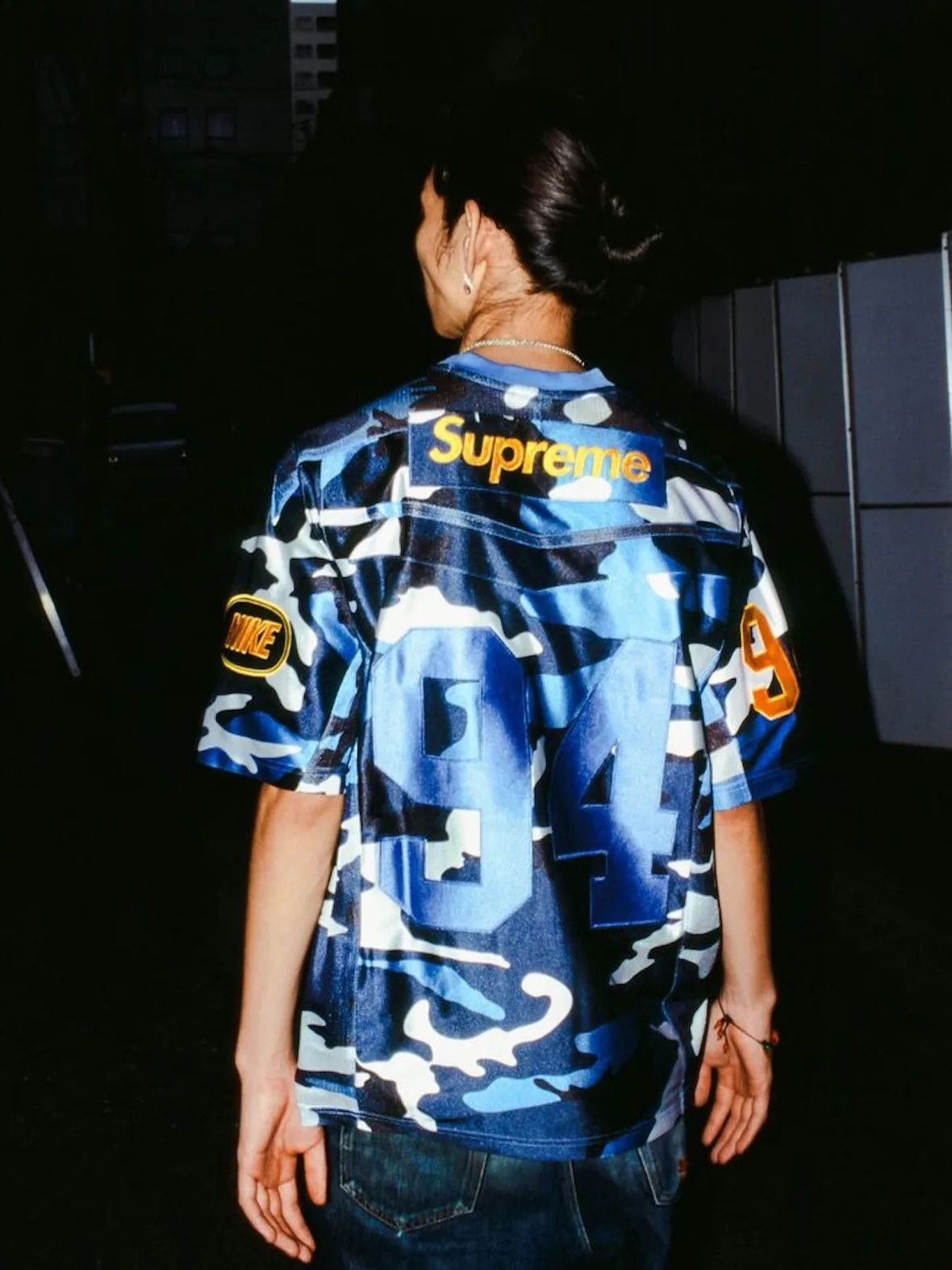 back view, blue camo jersey with Supreme arch logo, Nike patch, number 94 on back, Fall 2026 Collection