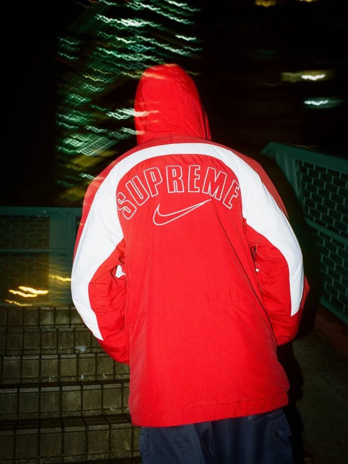 back view, red hooded jacket with white panels, Supreme arch logo and Nike swoosh, Fall 2026 Collection